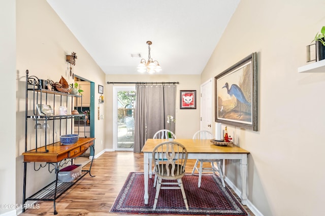 6 Wegeon Ln, Beaufort, SC 29906 - dining room featuring vaulted ceiling, a chandelier, and wood finished floors