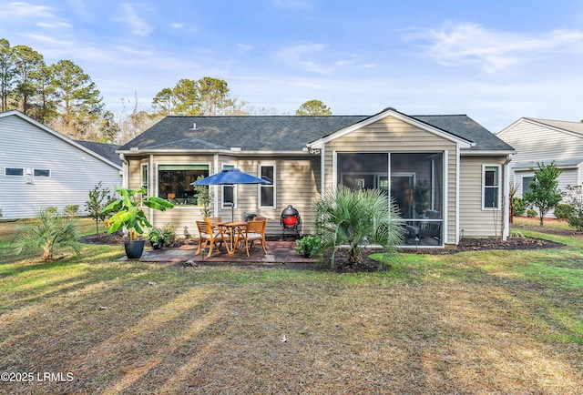 back of house featuring a patio, a sunroom, and a yard