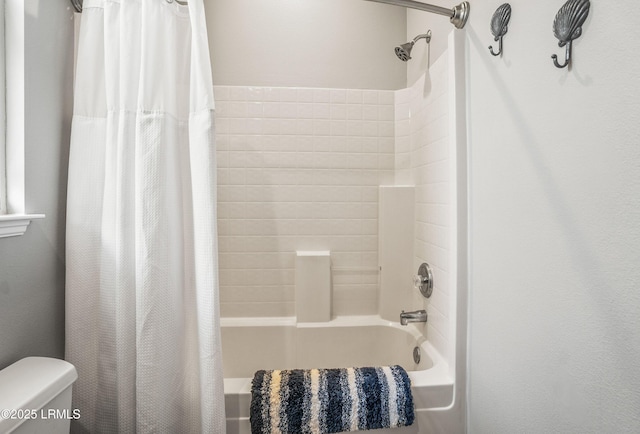 bathroom featuring toilet and shower / bathtub combination with curtain