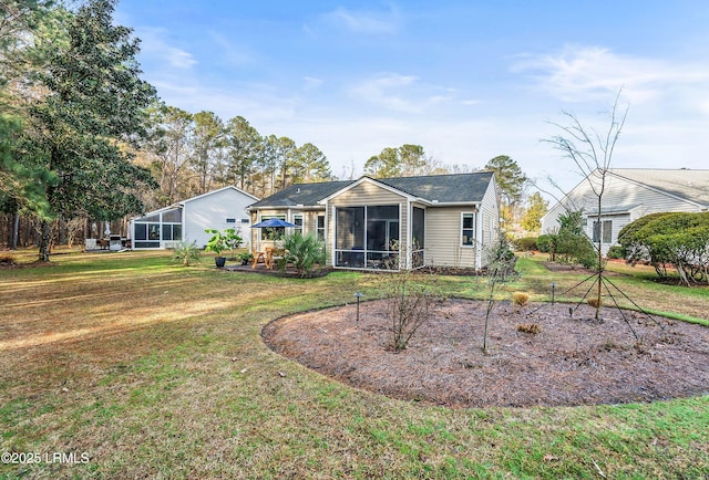 back of house with a sunroom and a lawn