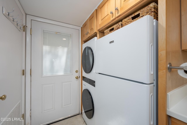 4 Marsh Harbor Dr Unit D, Beaufort, SC 29907 - laundry area with stacked washer / drying machine, cabinet space, and light tile patterned floors