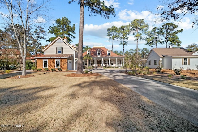 view of front of property with a porch and a front yard