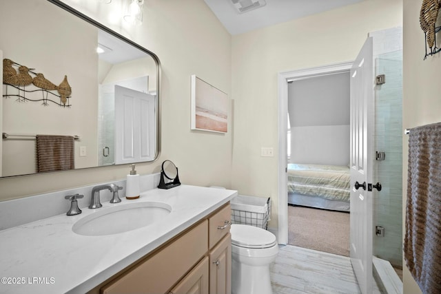 bathroom with vanity, lofted ceiling, toilet, and walk in shower