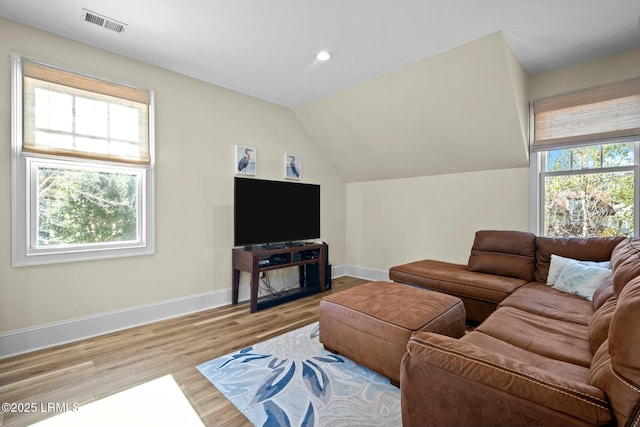 living room with vaulted ceiling and light hardwood / wood-style floors