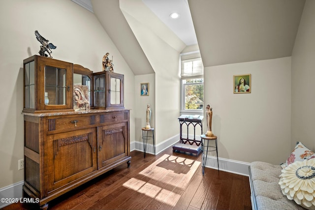 sitting room with vaulted ceiling and dark hardwood / wood-style flooring