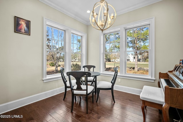 dining space featuring ornamental molding, dark hardwood / wood-style floors, and an inviting chandelier