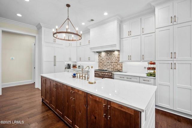 kitchen with pendant lighting, white cabinetry, double oven range, and custom exhaust hood