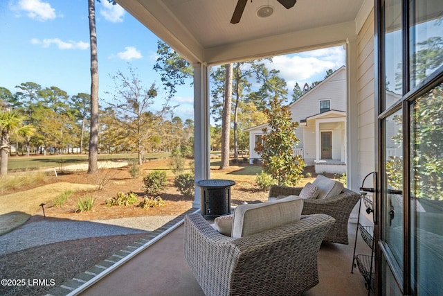 sunroom / solarium featuring a wealth of natural light and ceiling fan