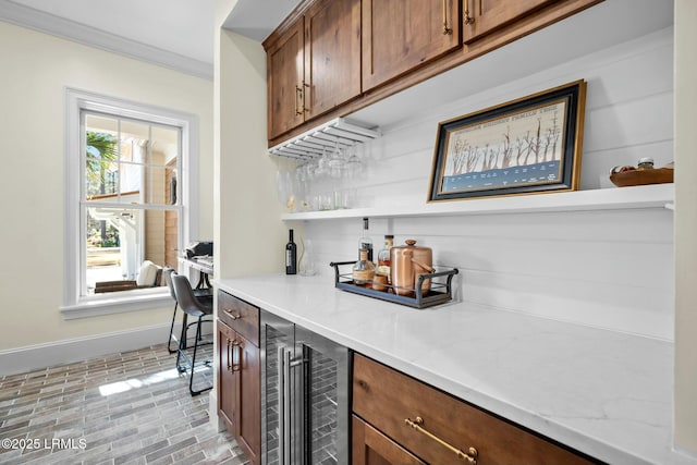 bar featuring backsplash, ornamental molding, and beverage cooler