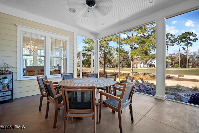 sunroom / solarium featuring ceiling fan