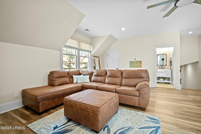 living room featuring hardwood / wood-style floors and ceiling fan