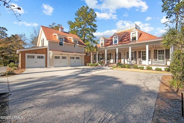 view of front of property with a porch and a garage