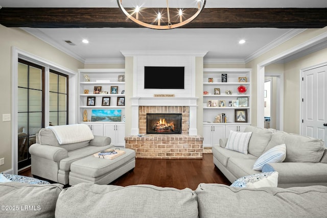 living room with crown molding, a brick fireplace, dark hardwood / wood-style floors, and built in shelves