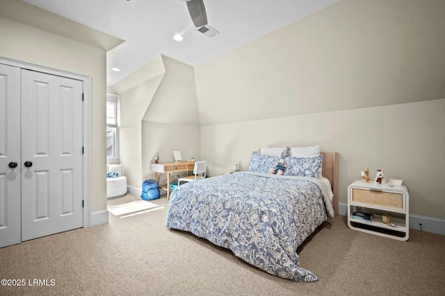 carpeted bedroom with vaulted ceiling, ceiling fan, and a closet