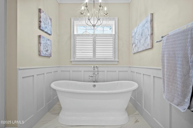 bathroom featuring a tub to relax in and a chandelier