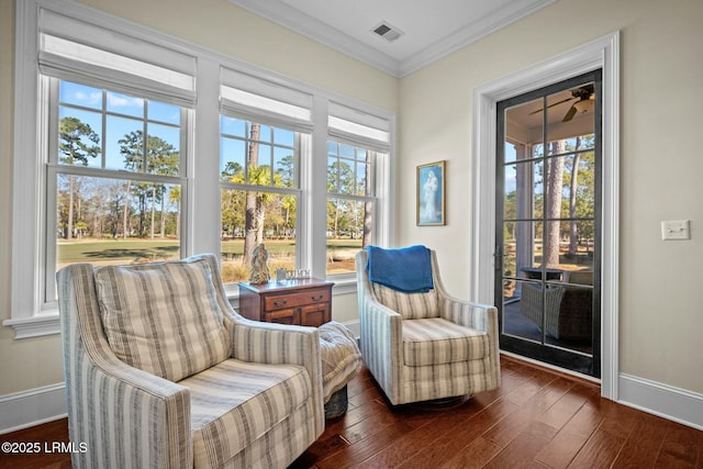 living area featuring ornamental molding and dark hardwood / wood-style flooring