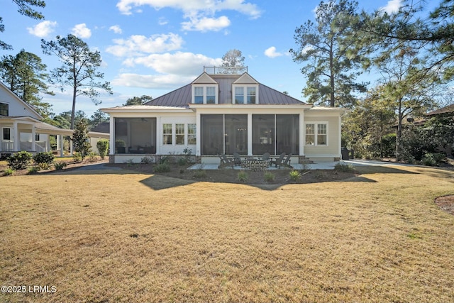 back of property with a yard and a sunroom