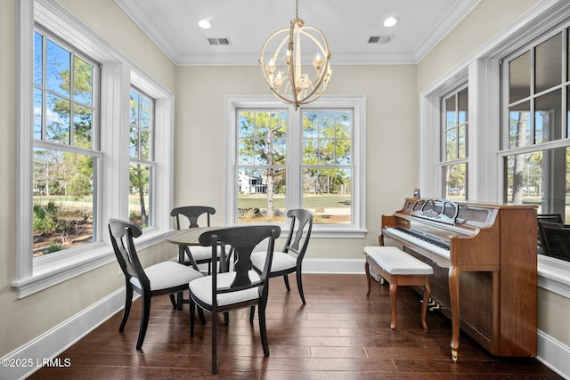 dining area featuring dark hardwood / wood-style flooring, a notable chandelier, and ornamental molding