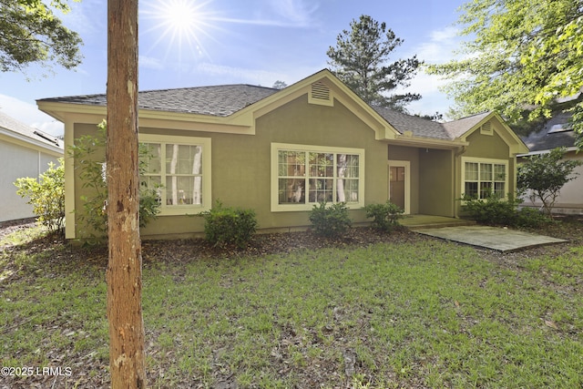 5 Canebrake Ln, Bluffton, SC 29910 - rear view of property with stucco siding, a lawn, and a shingled roof
