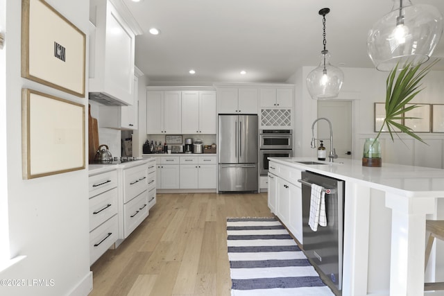 5 Canebrake Ln, Bluffton, SC 29910 - kitchen with appliances with stainless steel finishes, a sink, light wood-type flooring, white cabinetry, and recessed lighting
