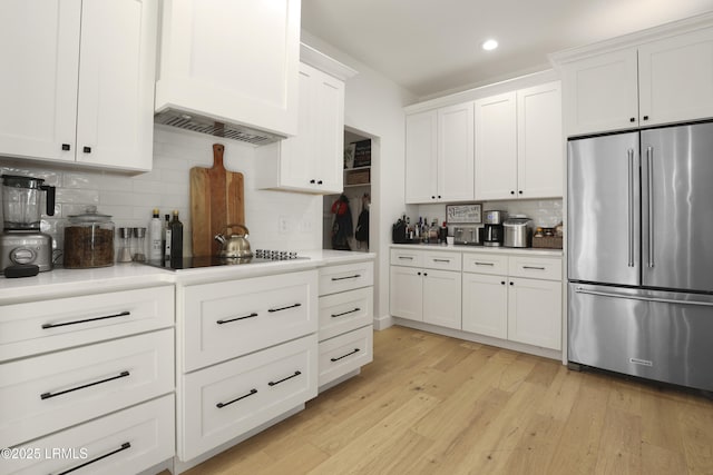 5 Canebrake Ln, Bluffton, SC 29910 - kitchen with high end refrigerator, decorative backsplash, white cabinets, recessed lighting, and light wood-style flooring