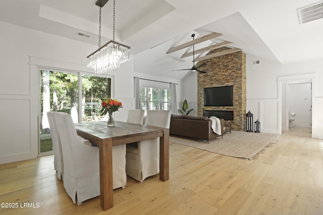 5 Canebrake Ln, Bluffton, SC 29910 - dining area with a decorative wall, light wood finished floors, a towering ceiling, ceiling fan, and a wainscoted wall