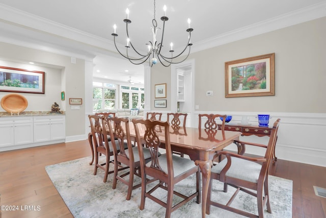 dining area with crown molding, ceiling fan, and light wood-type flooring