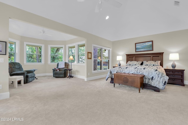 bedroom featuring multiple windows, light colored carpet, and ceiling fan