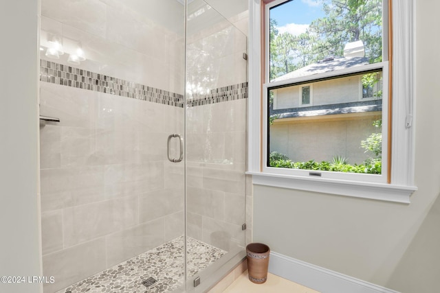 bathroom featuring a shower with shower door