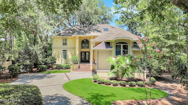 view of front of home with a front lawn and french doors