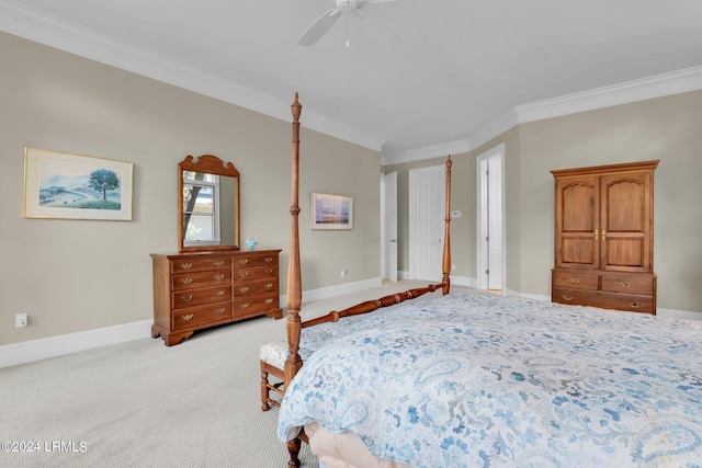 carpeted bedroom with ornamental molding and ceiling fan