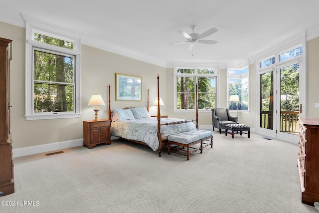 carpeted bedroom featuring multiple windows, ornamental molding, access to outside, and ceiling fan