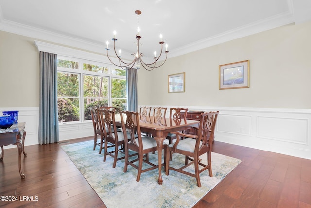 dining room featuring an inviting chandelier, dark wood-type flooring, and ornamental molding