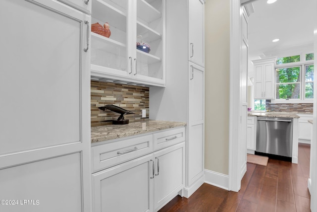 kitchen with tasteful backsplash, stainless steel dishwasher, dark hardwood / wood-style flooring, and white cabinets