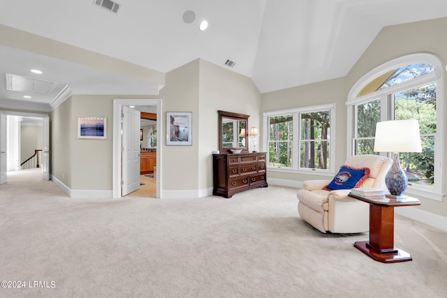 living area featuring a wealth of natural light, lofted ceiling, and light carpet