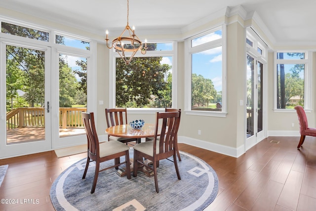 sunroom / solarium featuring a notable chandelier and french doors