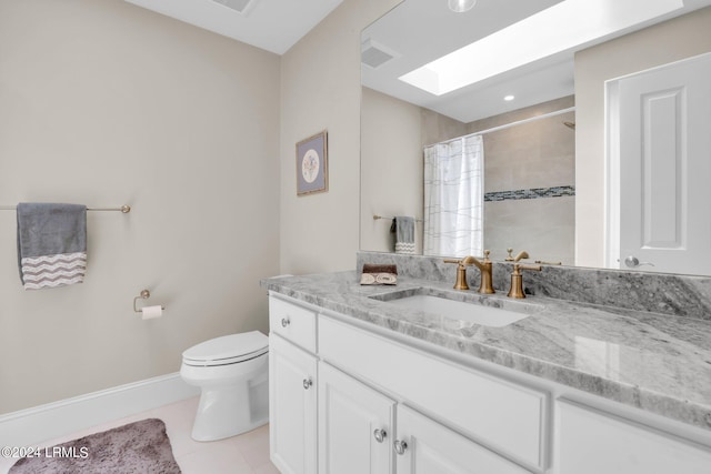 bathroom featuring walk in shower, toilet, a skylight, vanity, and tile patterned flooring