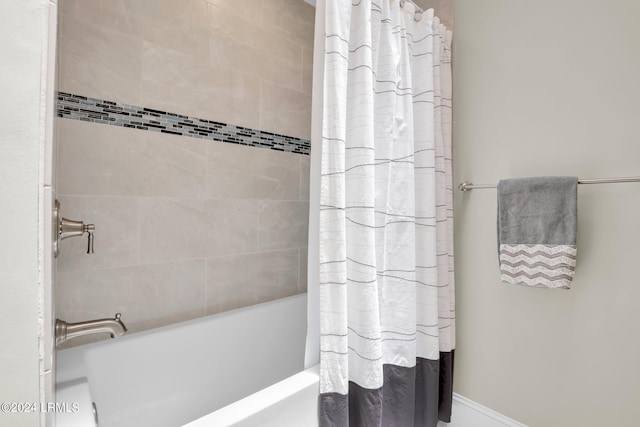 bathroom featuring shower / tub combo with curtain