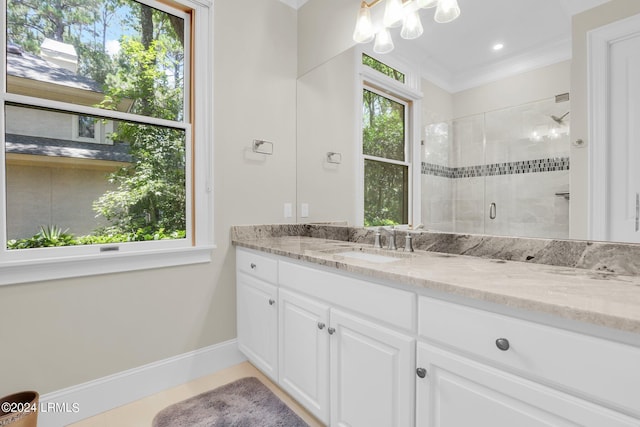 bathroom with crown molding, vanity, and an enclosed shower