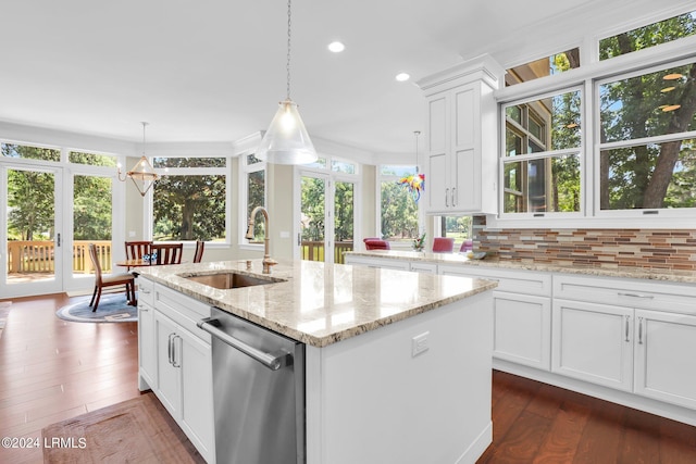 kitchen with decorative light fixtures, white cabinetry, dishwasher, sink, and an island with sink