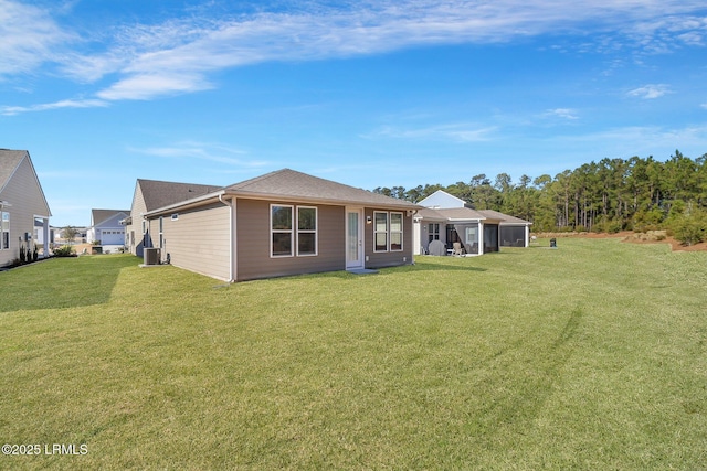 back of property featuring a yard and central AC unit