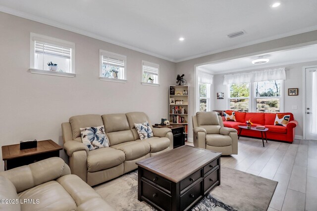 living room featuring crown molding and light hardwood / wood-style floors