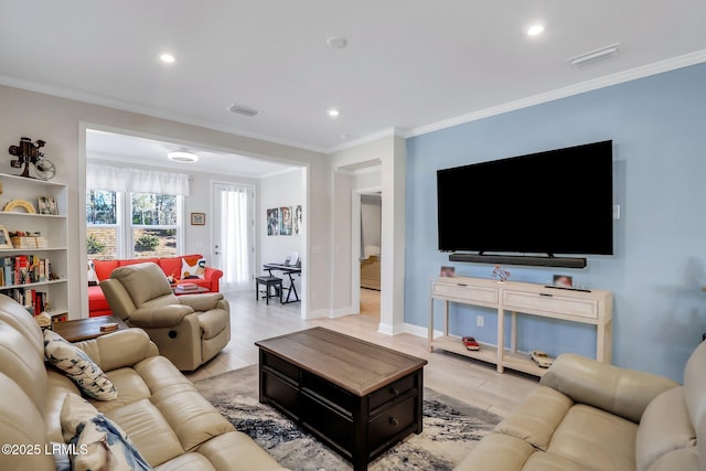 living room featuring ornamental molding and light hardwood / wood-style flooring