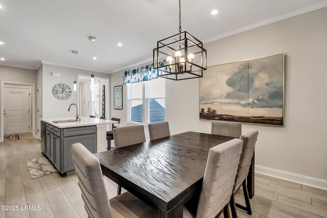 dining space featuring ornamental molding and sink