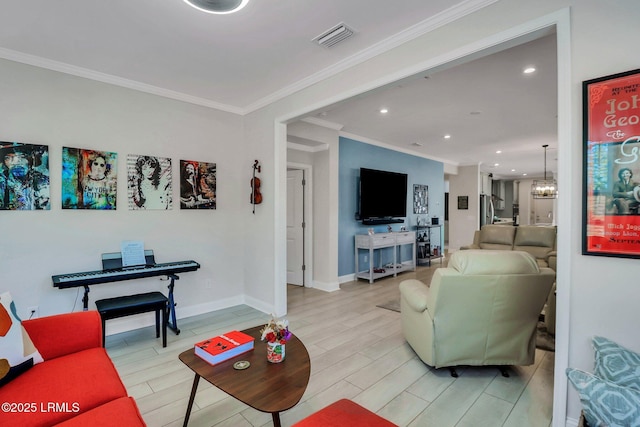 living room with ornamental molding, a chandelier, and light hardwood / wood-style floors