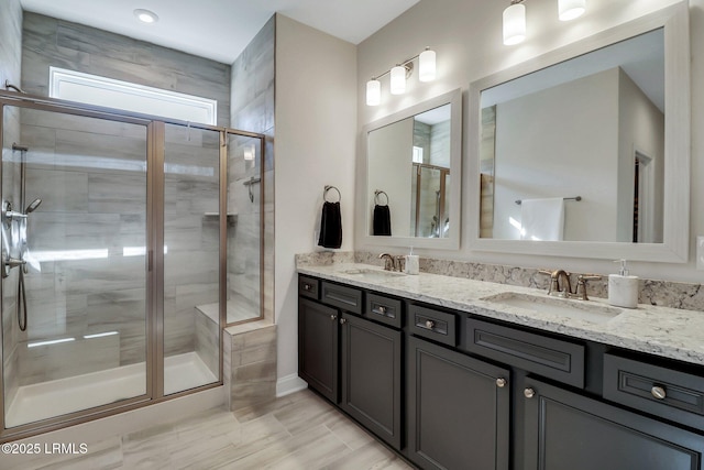 bathroom with vanity and a shower with shower door