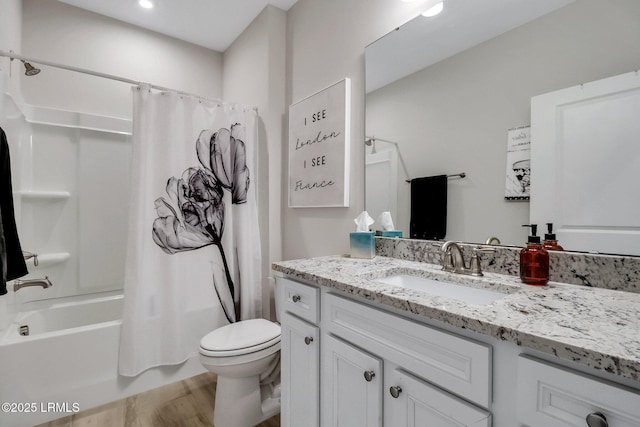 full bathroom featuring hardwood / wood-style flooring, shower / tub combo with curtain, vanity, and toilet