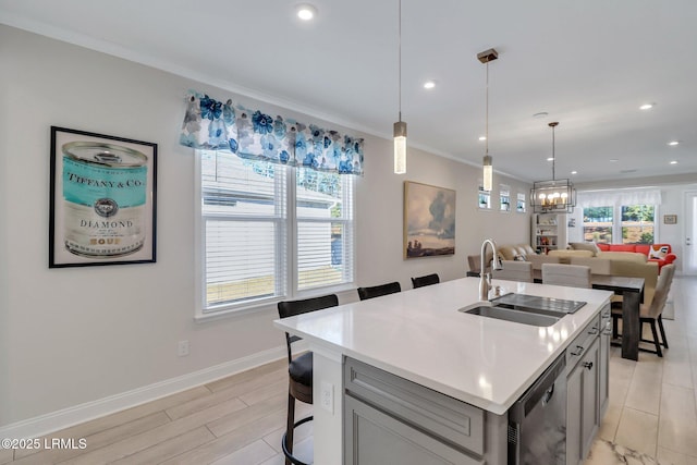 kitchen featuring an island with sink, a kitchen breakfast bar, black dishwasher, and sink