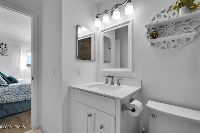 663 William Hilton Pkwy # 2309, Hilton Head Island, SC 29928 - bathroom featuring toilet, ornamental molding, wood finished floors, vanity, and ensuite bath