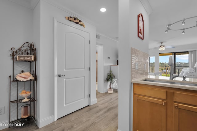 663 William Hilton Pkwy # 2309, Hilton Head Island, SC 29928 - hallway with light wood-style flooring, a sink, baseboards, recessed lighting, and ornamental molding